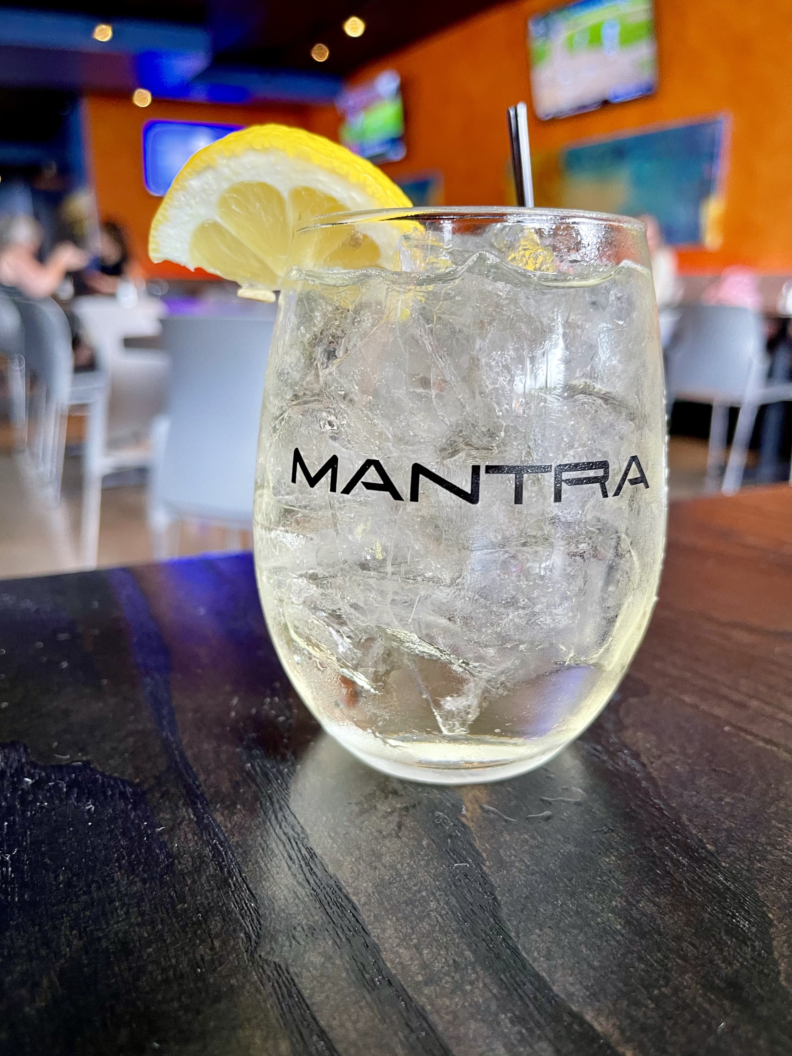 Mantra signature cocktail in branded stemless glass