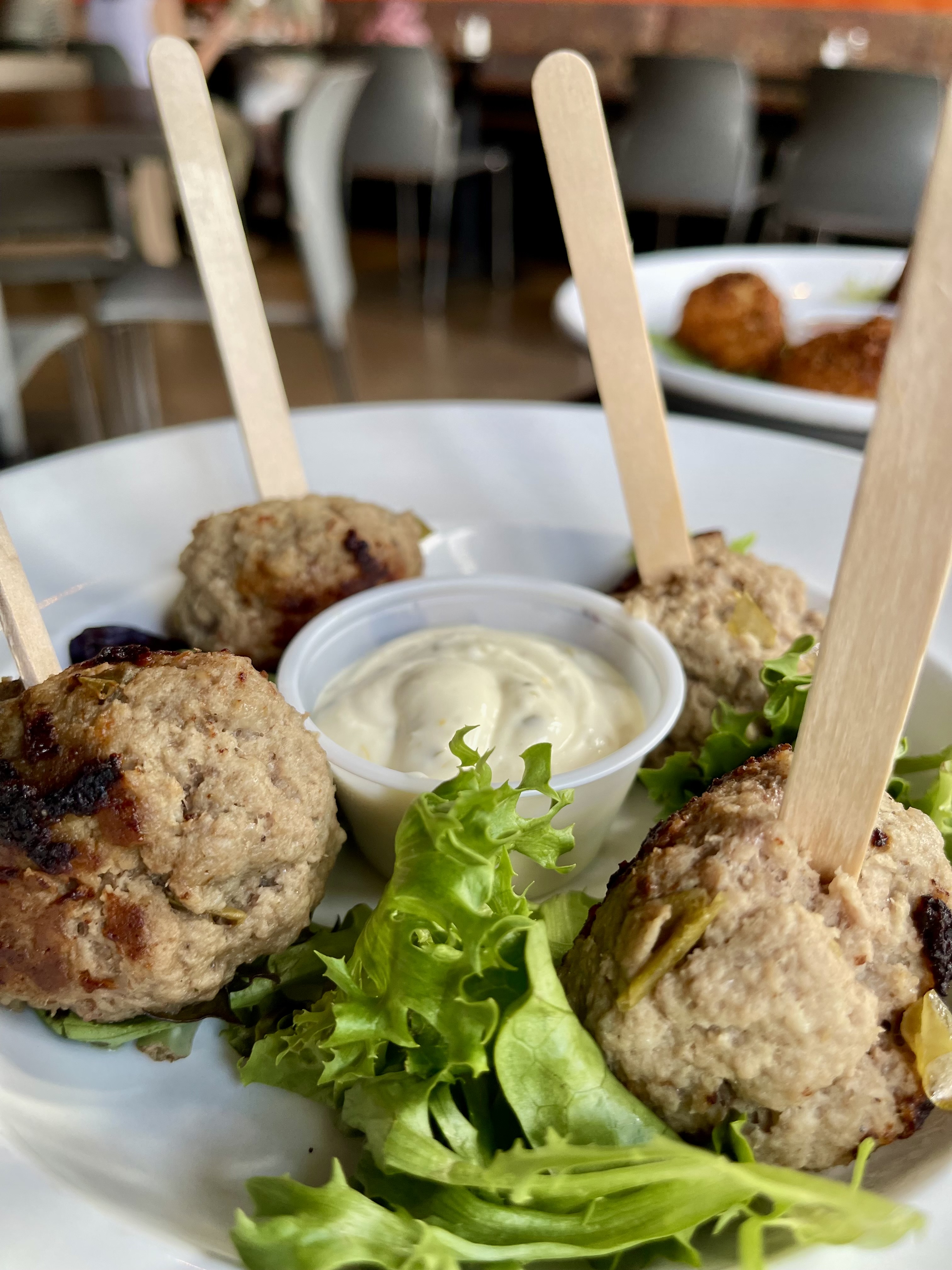 Mantra Lollipops — signature lamb & pork on sticks with cilantro shallot cream sauce